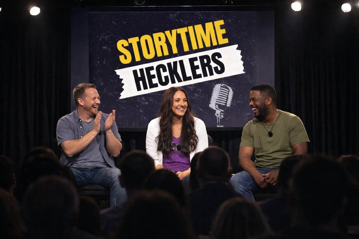 People laughing on a small stage under a yellow light